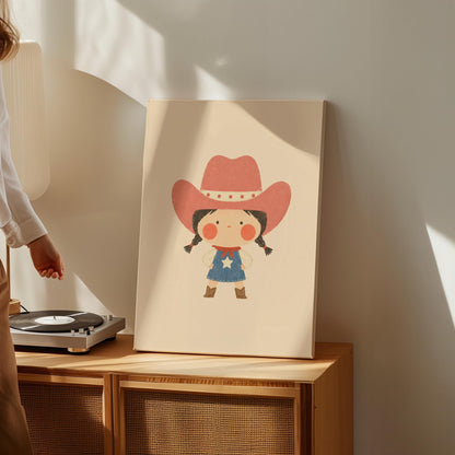 Small cowgirl in a star dress and coral hat with hands on hips, canvas print shown to scale in a furnished room