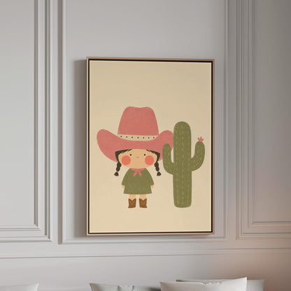 Little cowgirl in a pink hat next to a tall flowering cactus, canvas print in a bright room with natural daylight