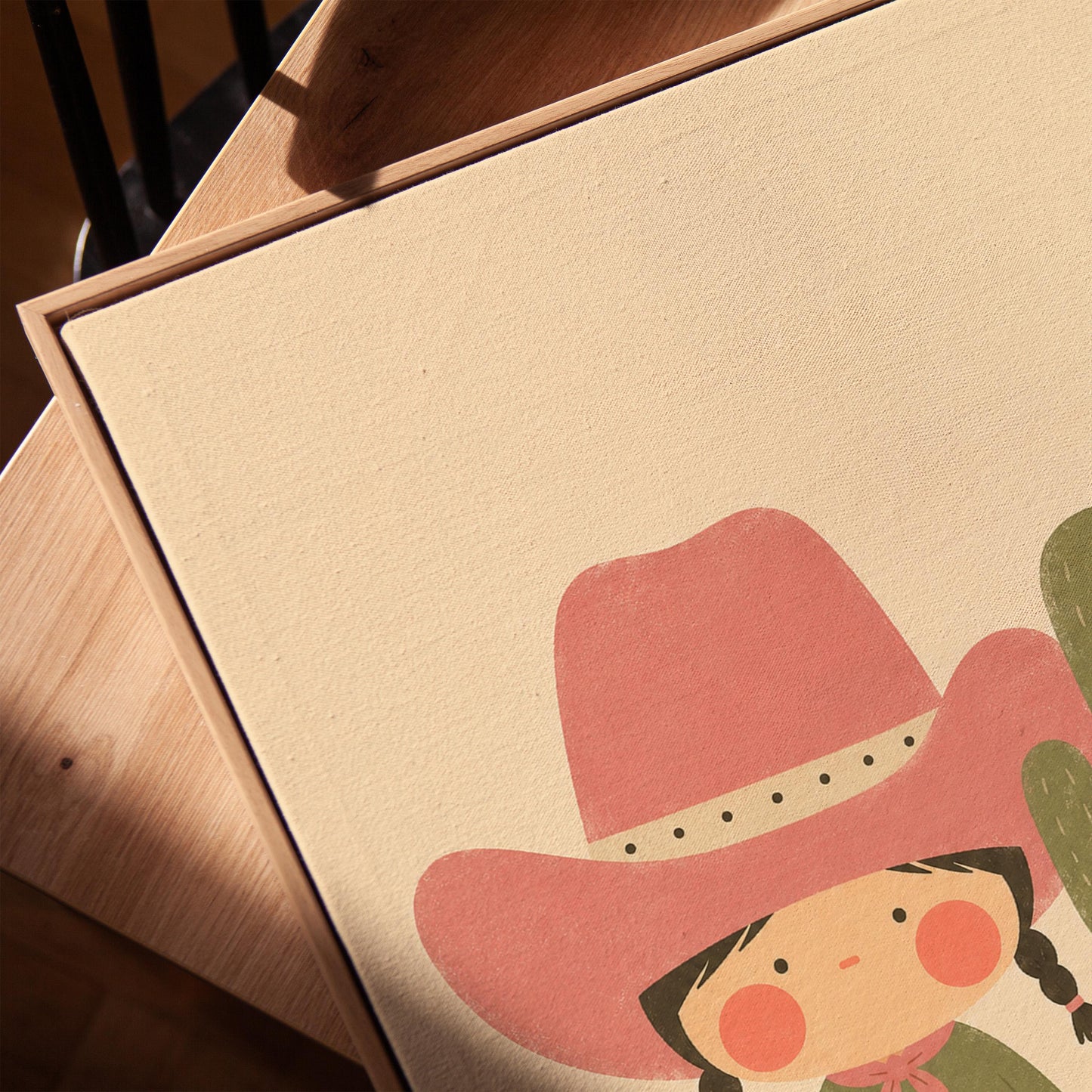 Little cowgirl in a pink hat next to a tall flowering cactus, canvas print in a warm, minimally styled interior