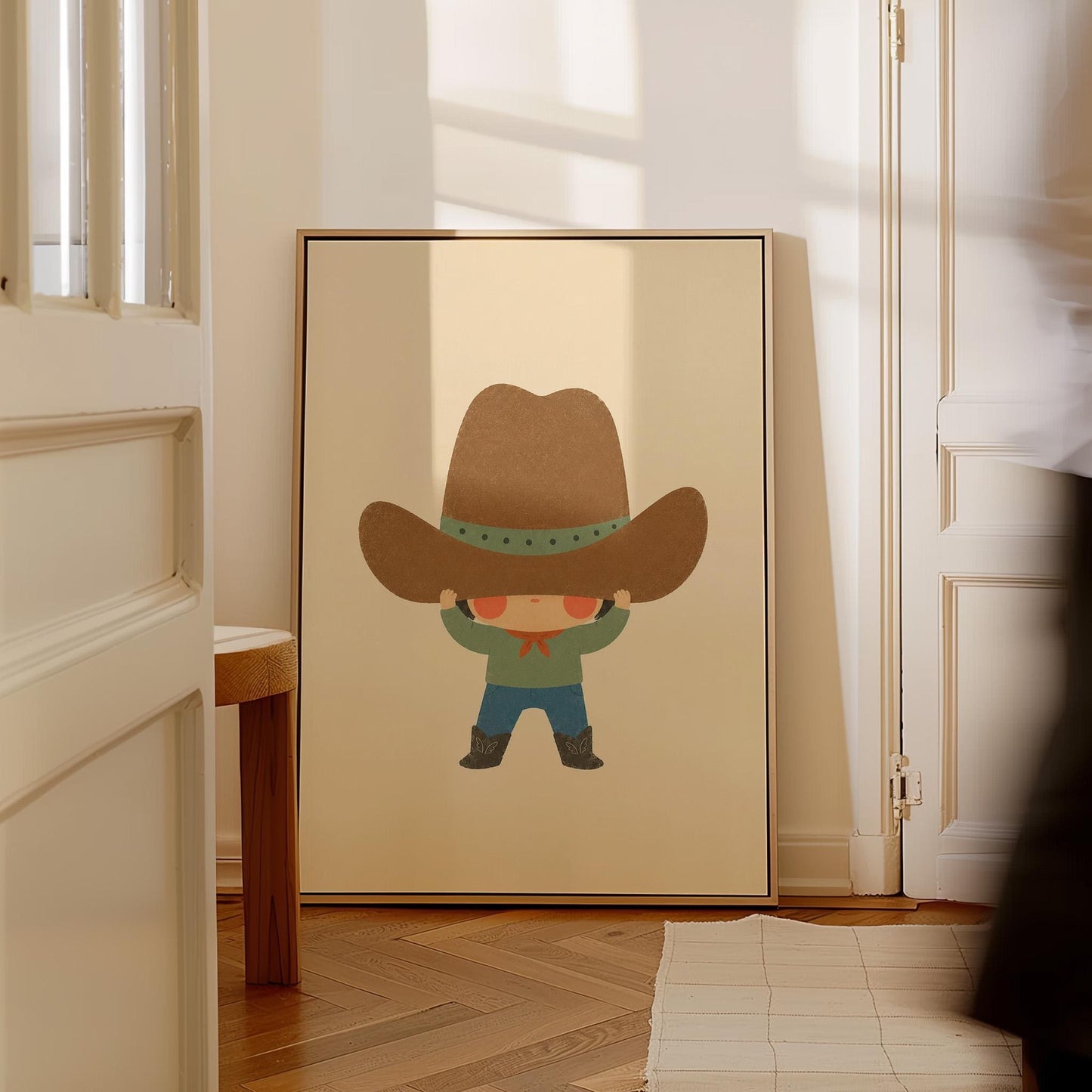 Child lifting an enormous brown cowboy hat above their eyes, canvas print styled against a soft white wall