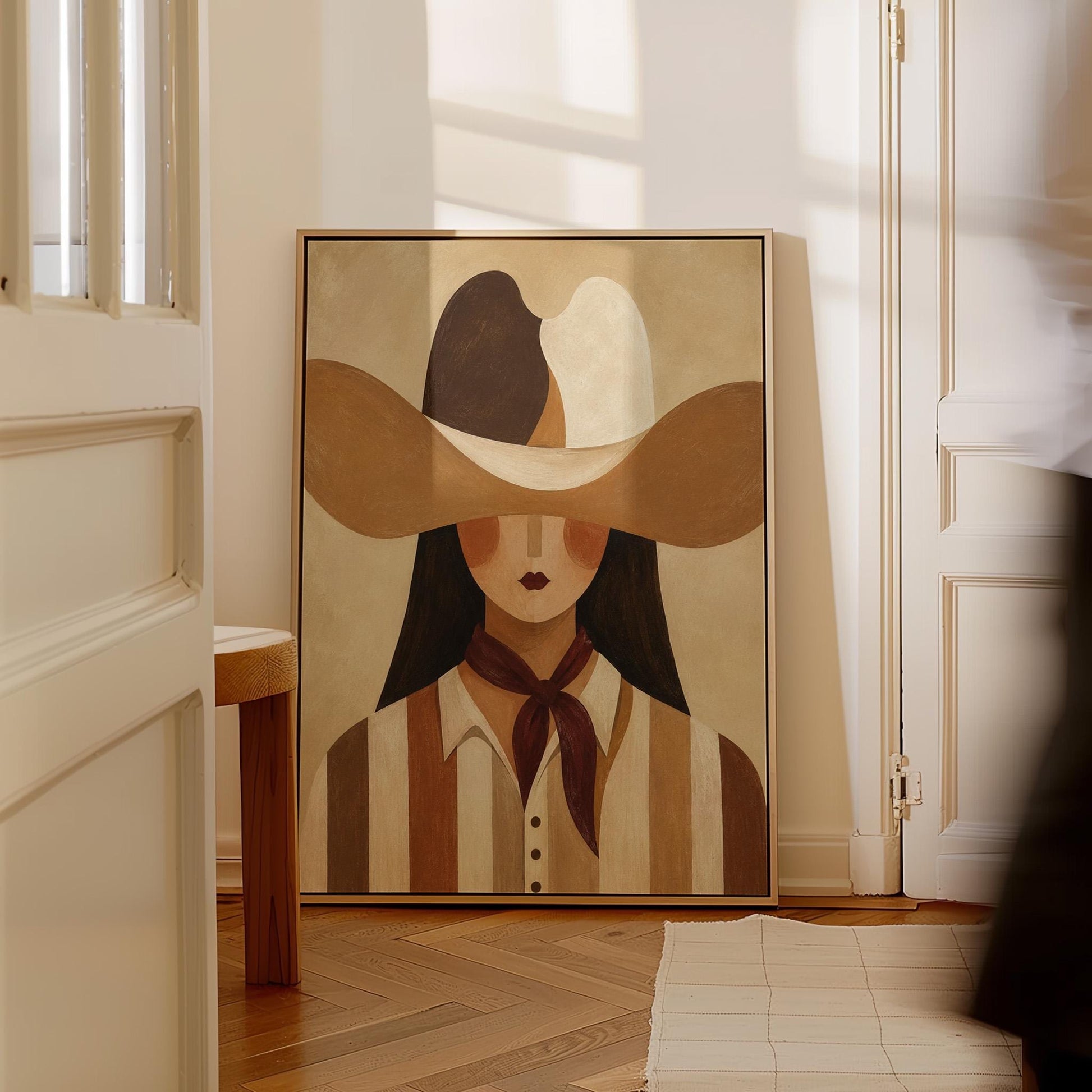 Cowgirl in a sweeping two-tone hat with a burgundy neckerchief, canvas wall art styled against a soft white wall