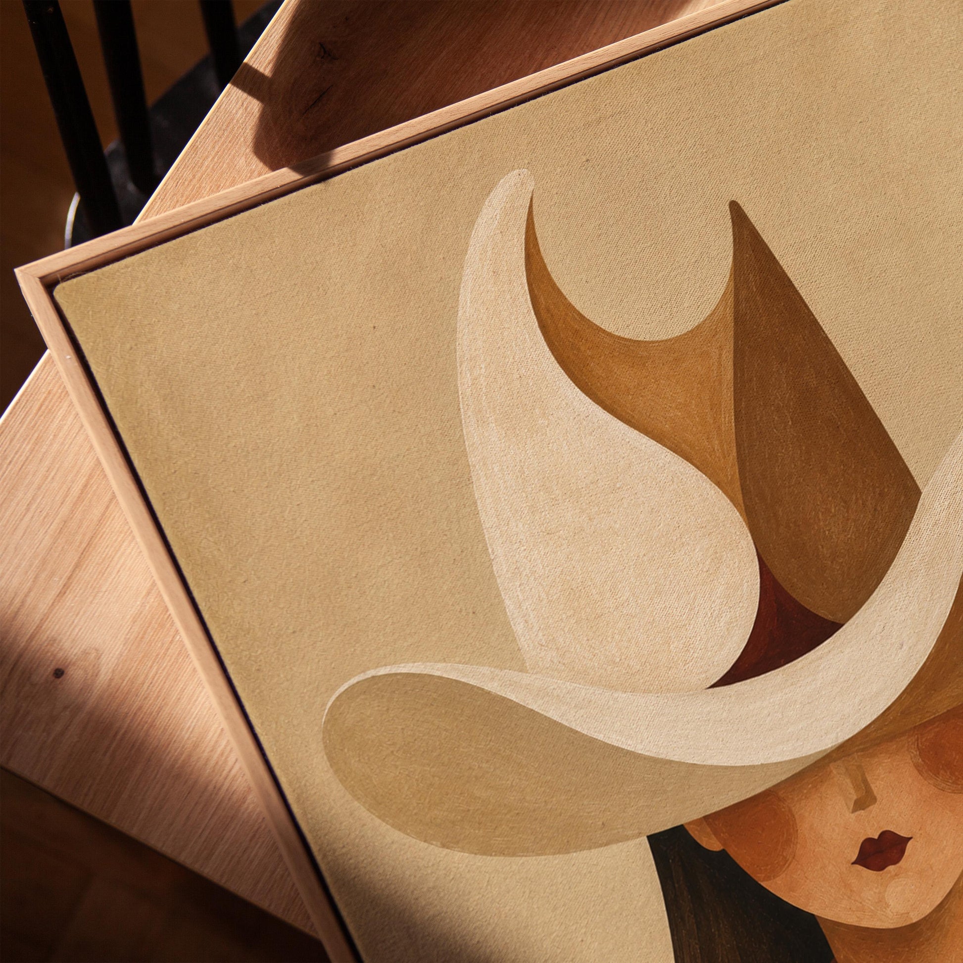 Cowgirl beneath a curling cream and brown wave shaped hat, canvas print in a warm, minimally styled interior
