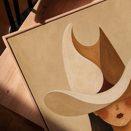 Cowgirl beneath a curling cream and brown wave shaped hat, canvas print in a warm, minimally styled interior