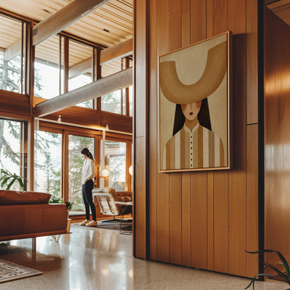 Faceless cowgirl under an enormous curved tan cowboy hat brim shape, canvas print displayed on a neutral wall in a styled interior
