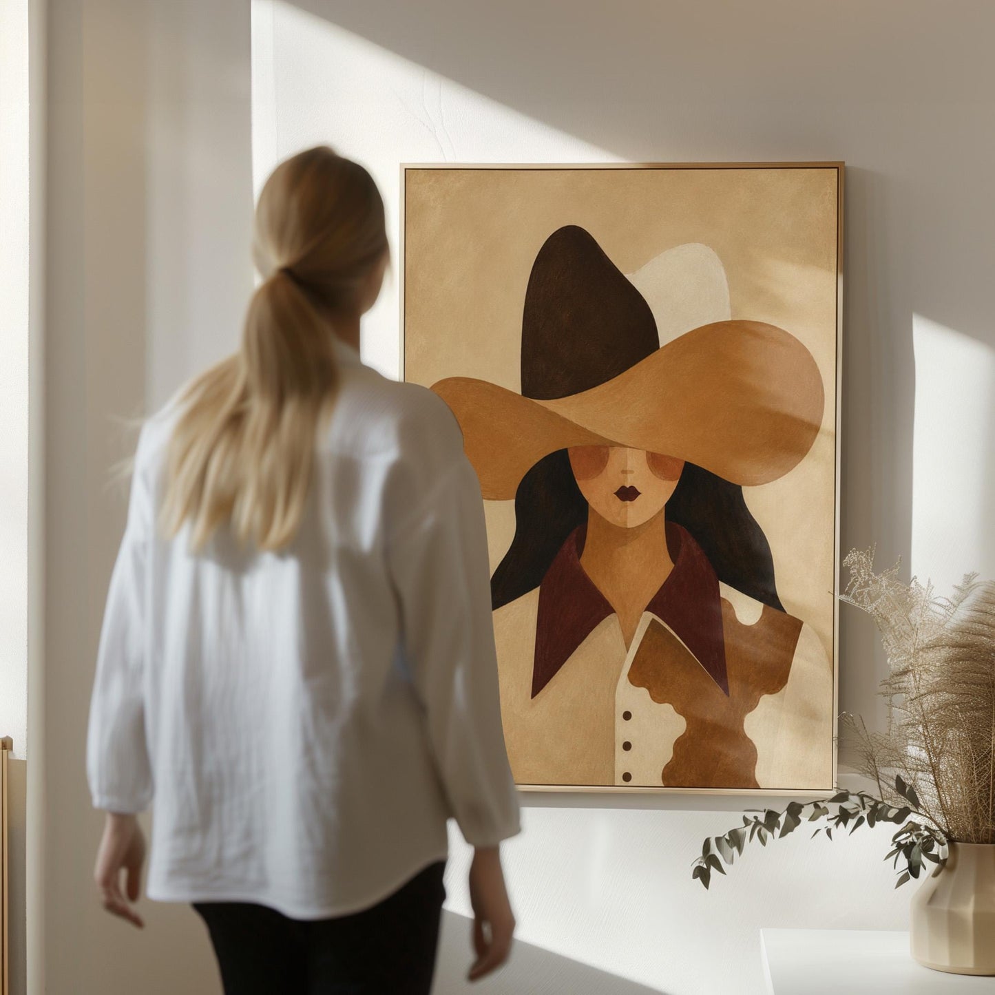 Cowgirl in a black and brown hat wearing a cow print shirt, canvas print seen in a warm interior with natural light