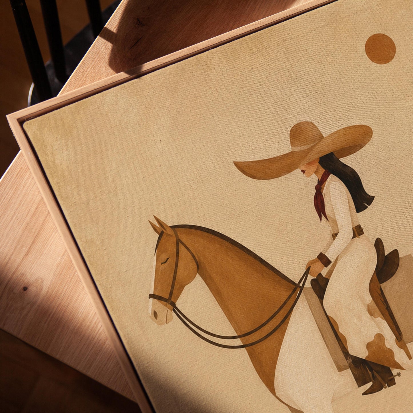 Cowgirl in a broad straw hat riding a cream and chestnut pinto horse, canvas print in a warm, minimally styled interior