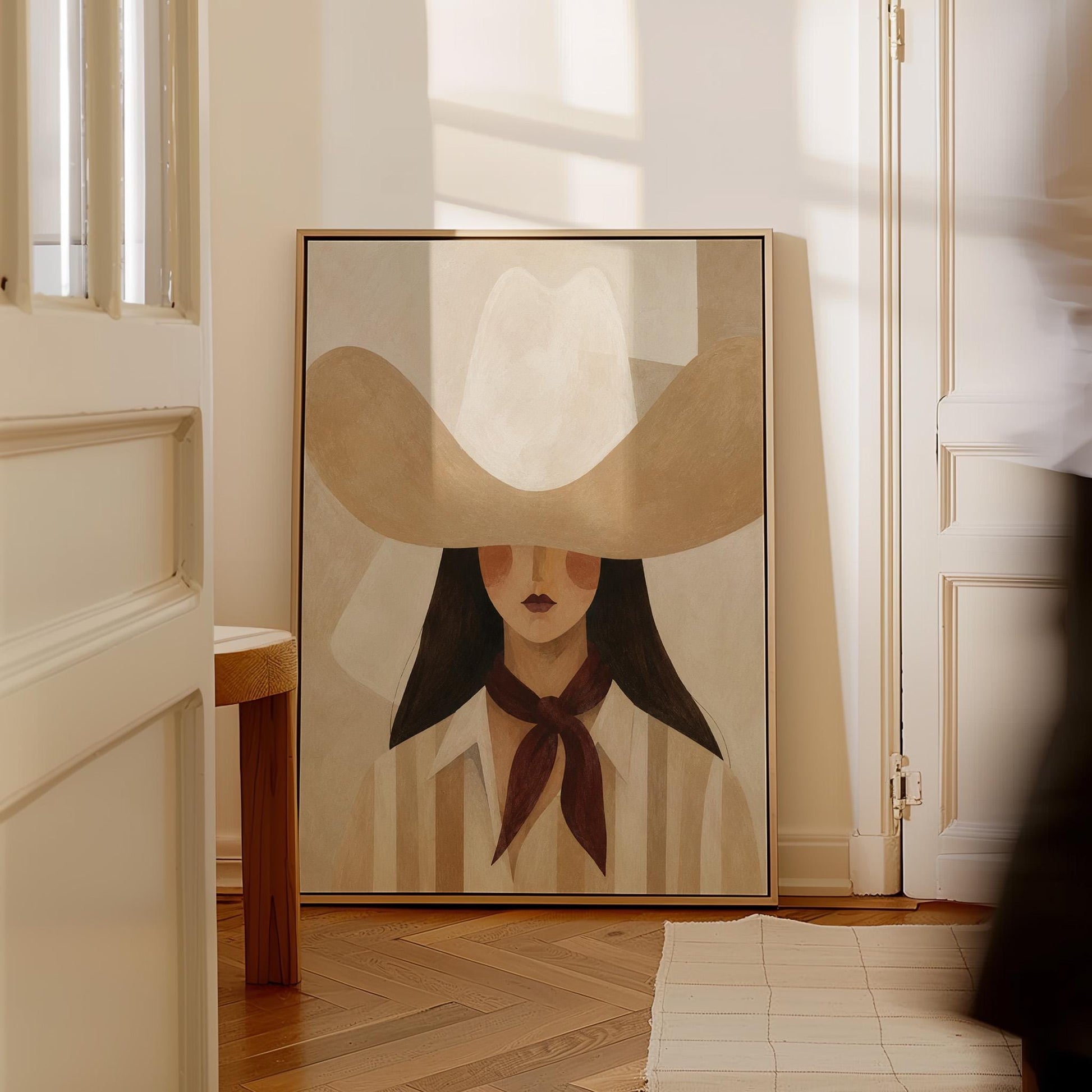 Close portrait of a cowgirl under a tan wide brim hat with a plum scarf, canvas print on a quiet wall in a considered interior