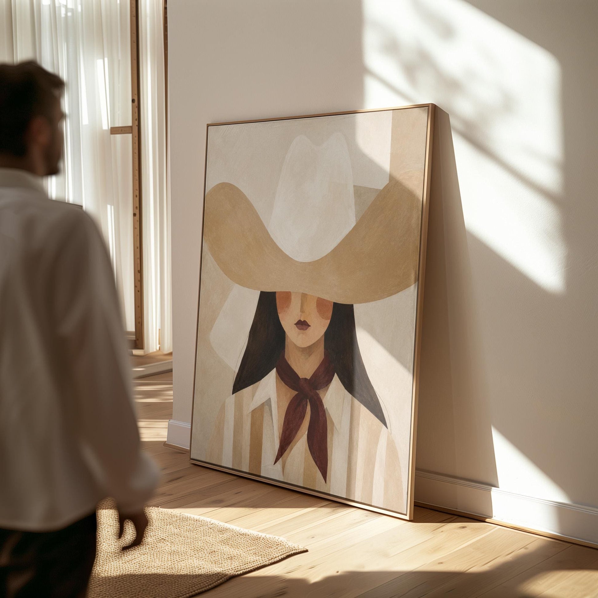 Close portrait of a cowgirl under a tan wide brim hat with a plum scarf, canvas print shown in a sunlit, contemporary room