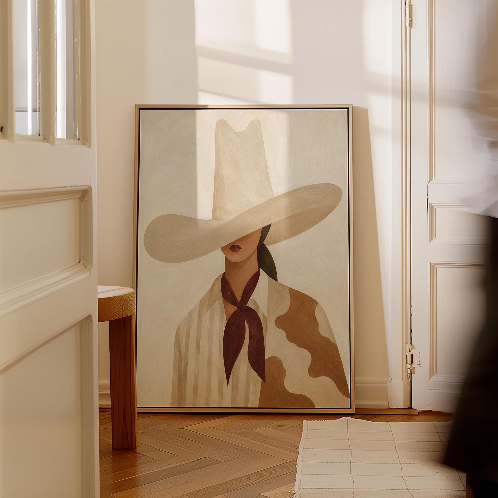 Cowgirl in a tall cream hat wearing a cowhide shawl and mauve scarf, canvas print shown to scale in a furnished room