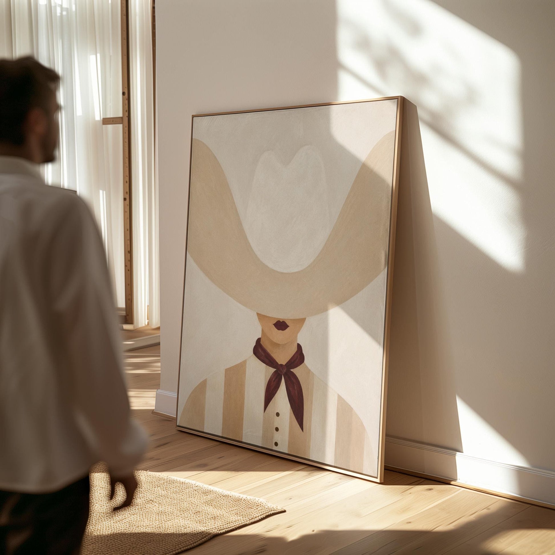 Woman under an oversized pale cowboy hat with a plum neckerchief, canvas wall art styled against a soft white wall