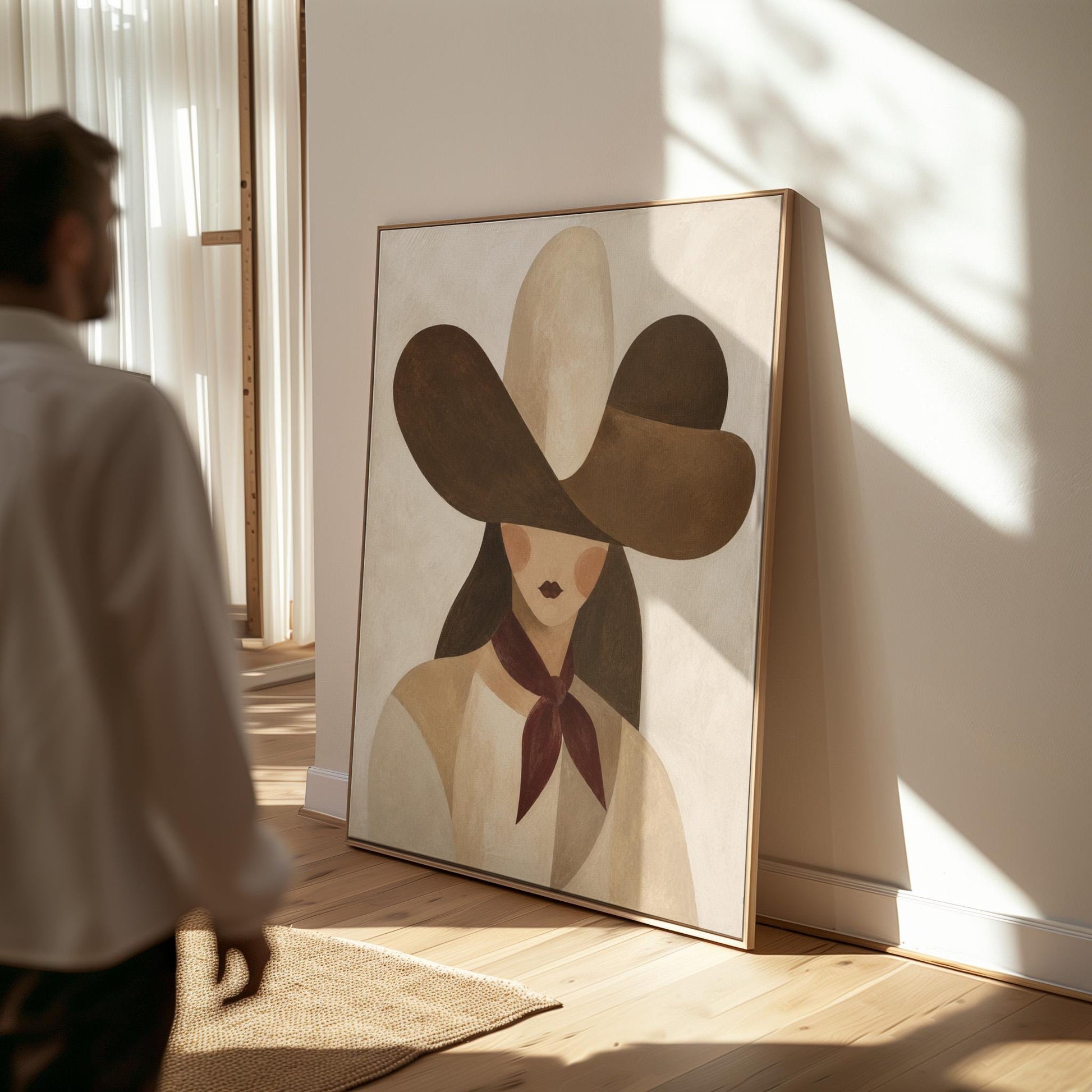 Woman in a deep brown cowboy hat with long hair and a wine red scarf, canvas print presented in a light, minimal room