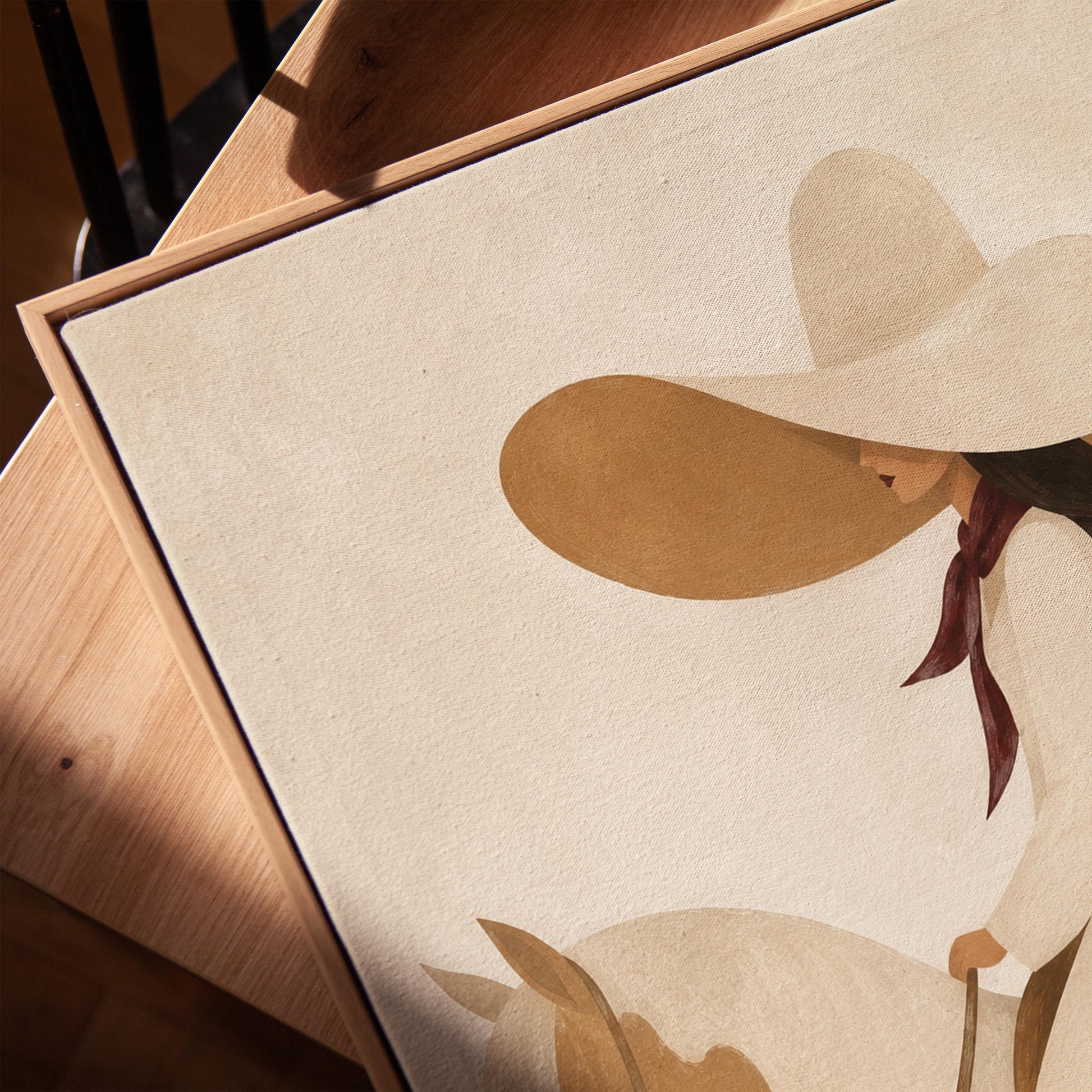 Woman in a long white dress and floppy hat riding a spotted horse, canvas print in a warm, minimally styled interior