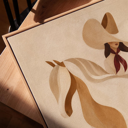 Stylised cream horse in curved shapes with a rider in white above it, canvas print in a warm, minimally styled interior