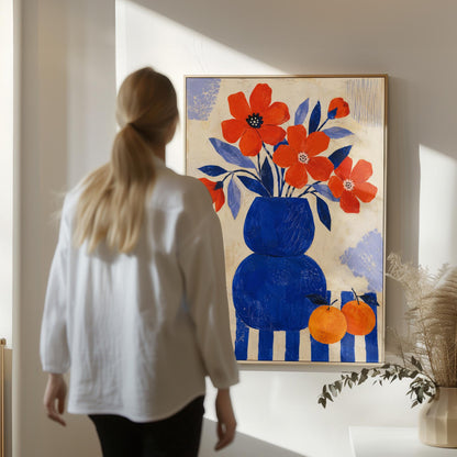 Scarlet poppies in a cobalt vase with oranges on a blue striped cloth, canvas print shown in a sunlit, contemporary room