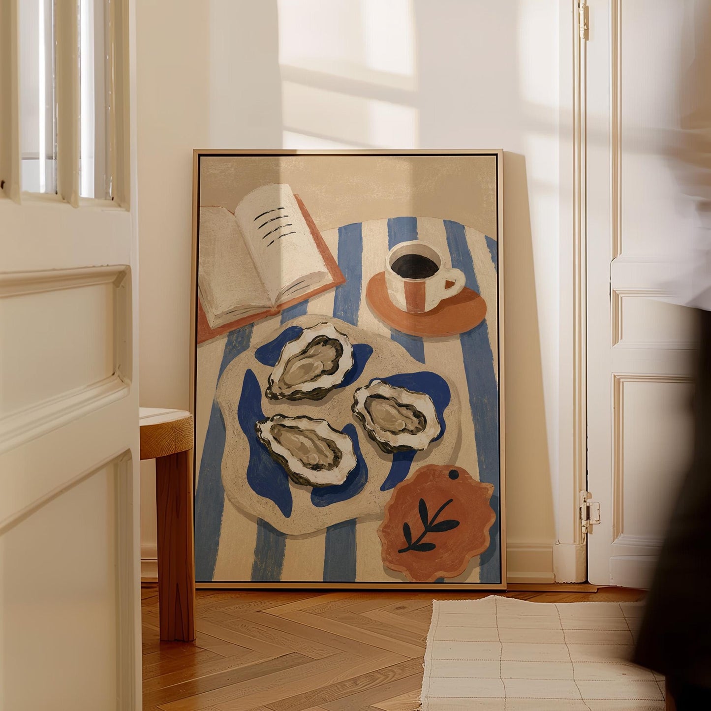 Plate of oysters with espresso and an open book on a striped cloth, canvas wall art seen in a warm interior with natural light