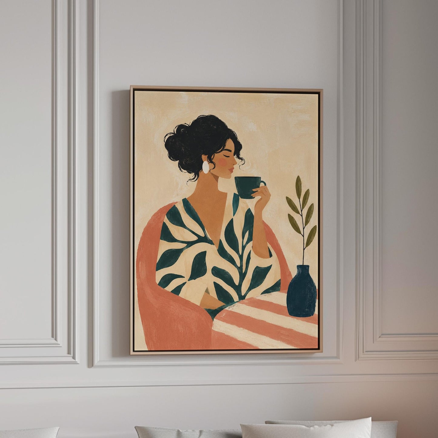 Woman in a leaf print robe drinking from a teal cup beside a vase, canvas print in a bright room with natural daylight
