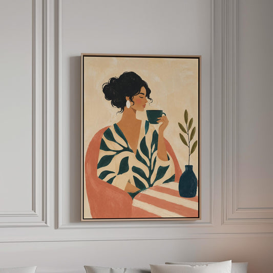 Woman in a leaf print robe drinking from a teal cup beside a vase, canvas print in a bright room with natural daylight
