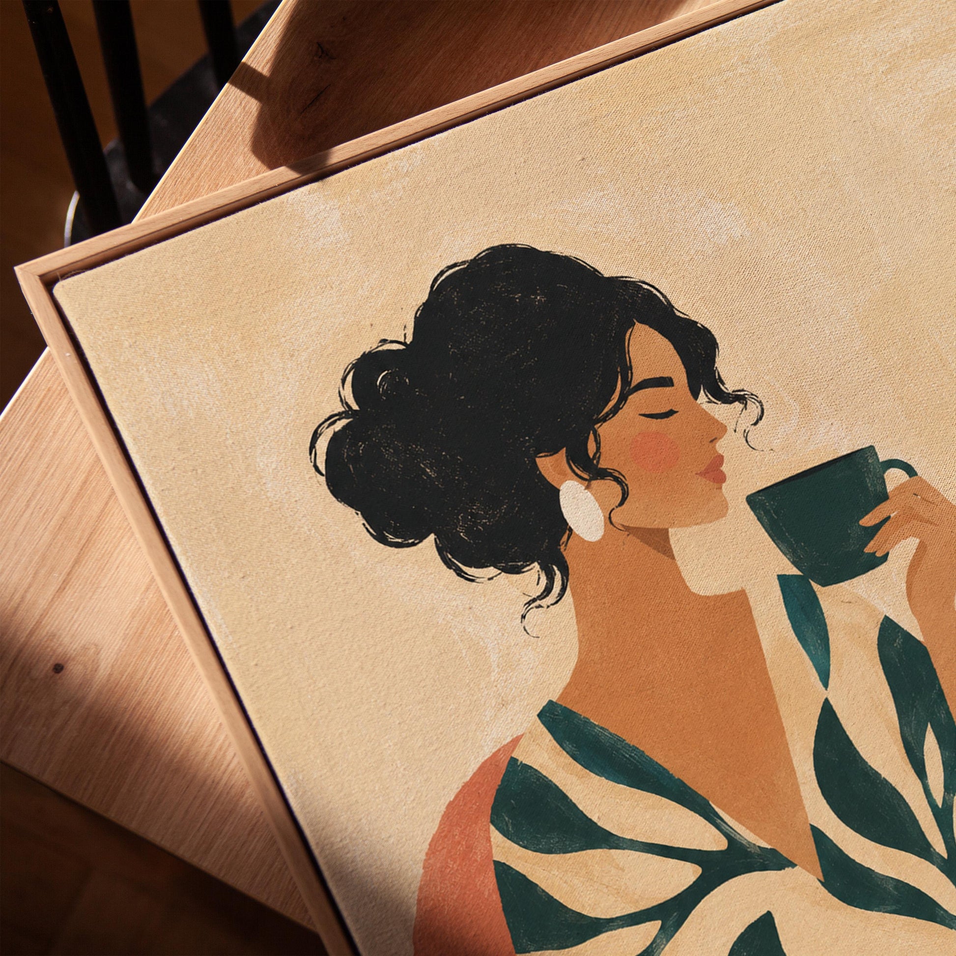 Woman in a leaf print robe drinking from a teal cup beside a vase, canvas print in a warm, minimally styled interior