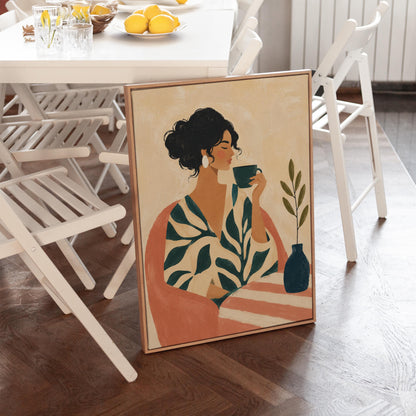 Woman in a leaf print robe drinking from a teal cup beside a vase, canvas print shown in a sunlit, contemporary room