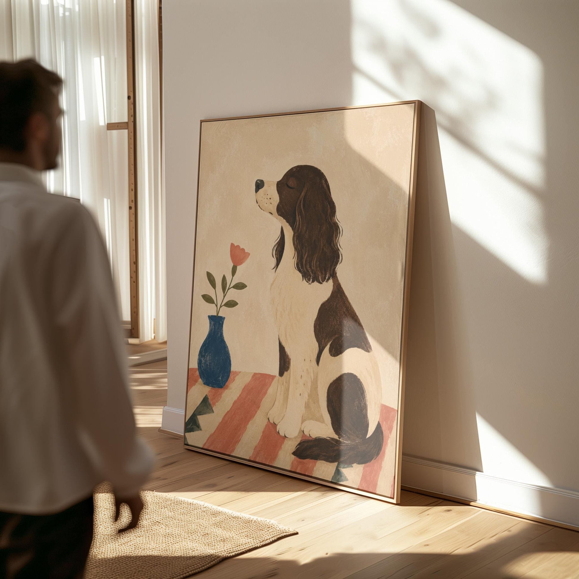 Brown and white spaniel sniffing a coral tulip in a small blue vase, canvas wall art presented in a light, minimal room
