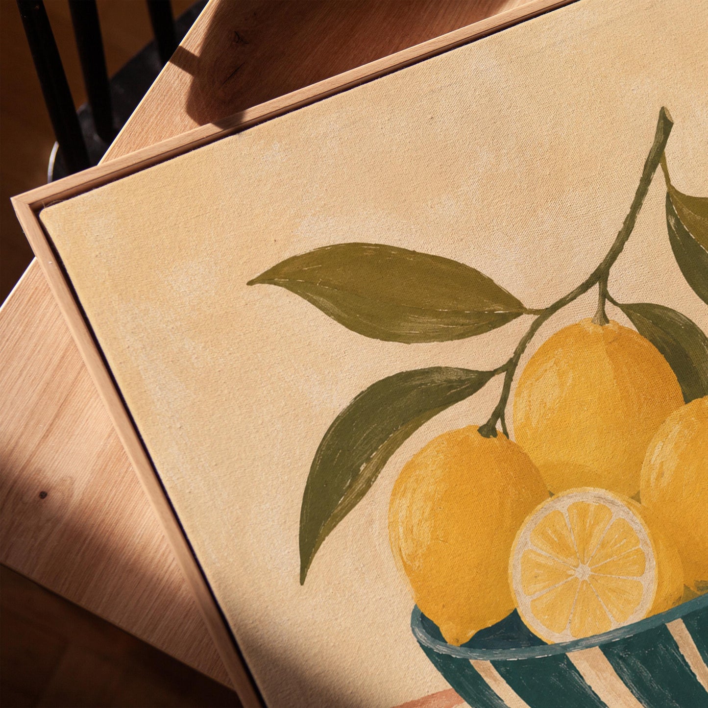 Lemons on the branch in a teal striped bowl on a pink striped cloth, canvas print in a warm, minimally styled interior