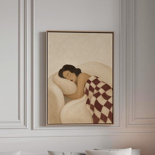 Woman sleeping under a burgundy and cream checkerboard blanket, canvas print in a bright room with natural daylight