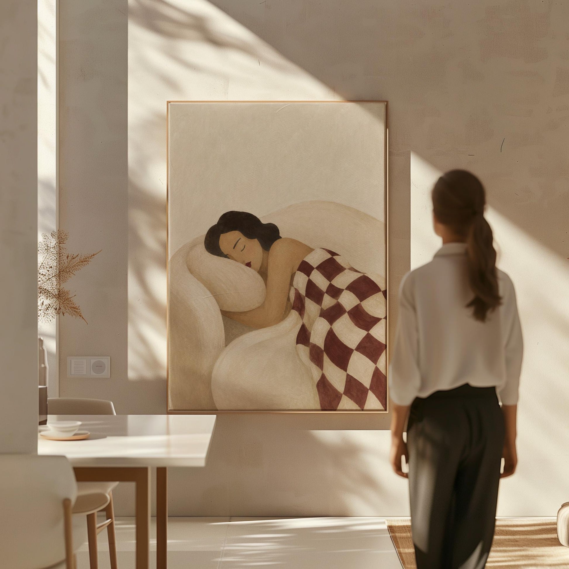 Woman sleeping under a burgundy and cream checkerboard blanket, canvas print shown in a sunlit, contemporary room