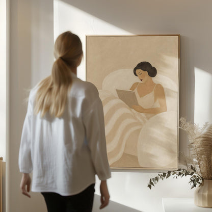 Woman in a white slip sitting up in bed reading in morning light, canvas print hanging in a calm, modern living space