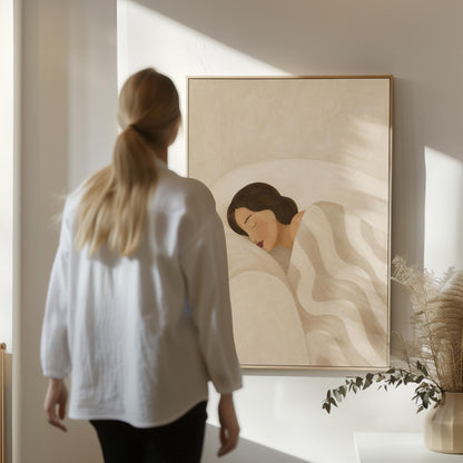 Woman asleep beneath a quilt of rolling cream and sand wave shapes, canvas wall art seen in a warm interior with natural light