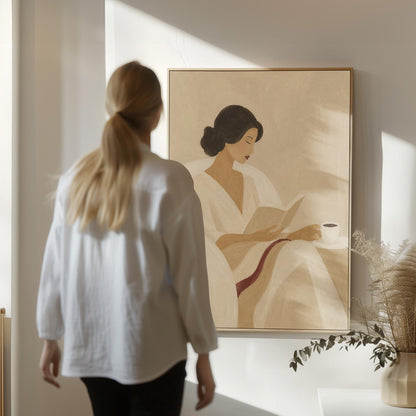 Woman in a white robe reading in an armchair with a black coffee, canvas print seen in a warm interior with natural light