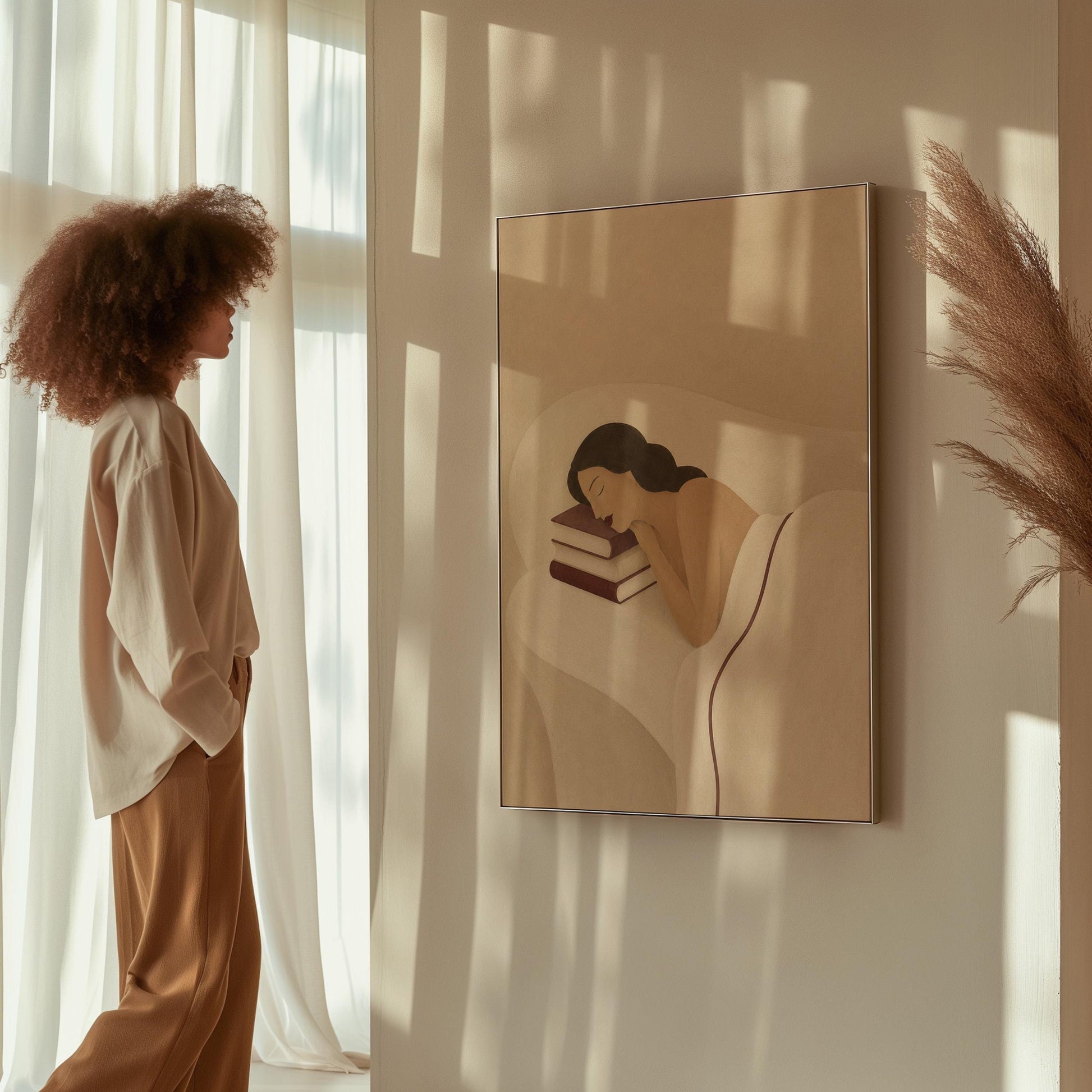 Woman resting her cheek on a stack of cream and burgundy books, canvas wall art hanging in a calm, modern living space