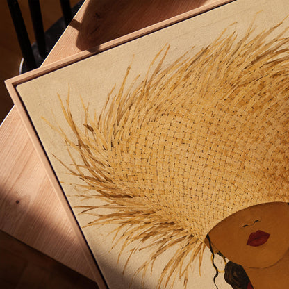 Woman in a huge fringed straw hat with a red scarf and striped shirt, canvas print in a warm, minimally styled interior