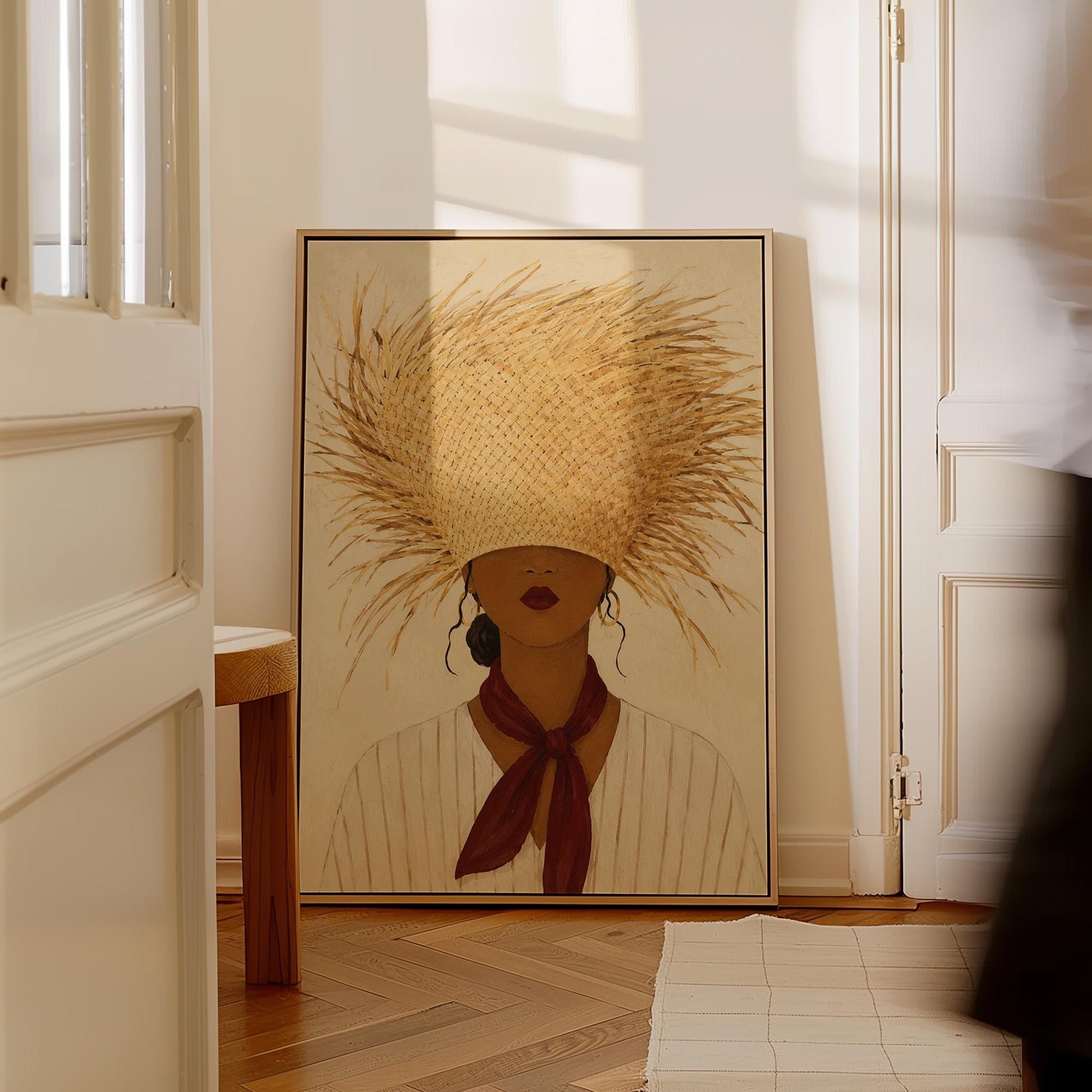 Woman in a huge fringed straw hat with a red scarf and striped shirt, canvas wall art seen in a warm interior with natural light