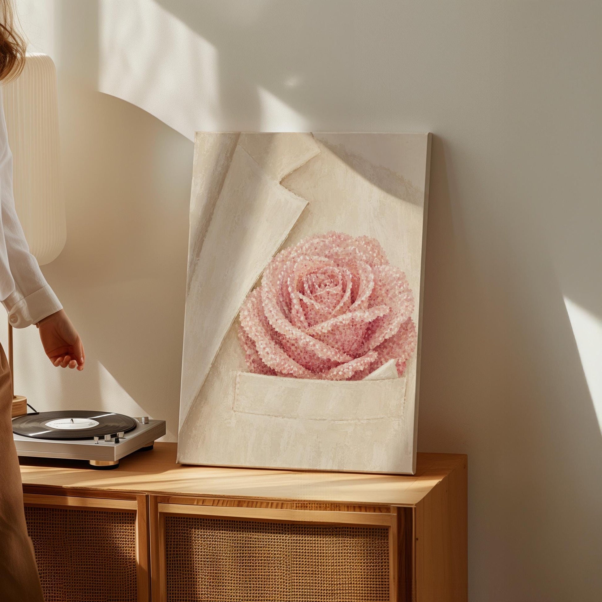 Blush pink rose with pearl beaded petals tucked into a cream pocket, canvas print displayed on a neutral wall in a styled interior