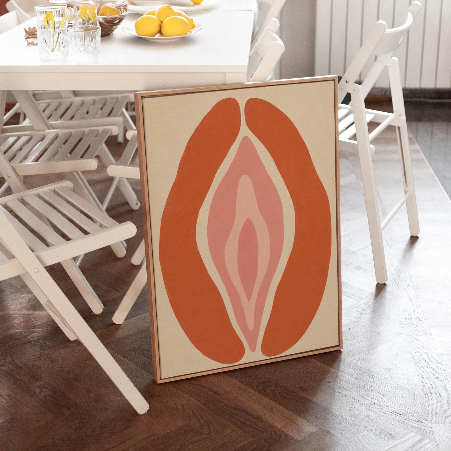 Rust orange arcs curving around a nested blush pink core on sand, canvas print presented in a light, minimal room