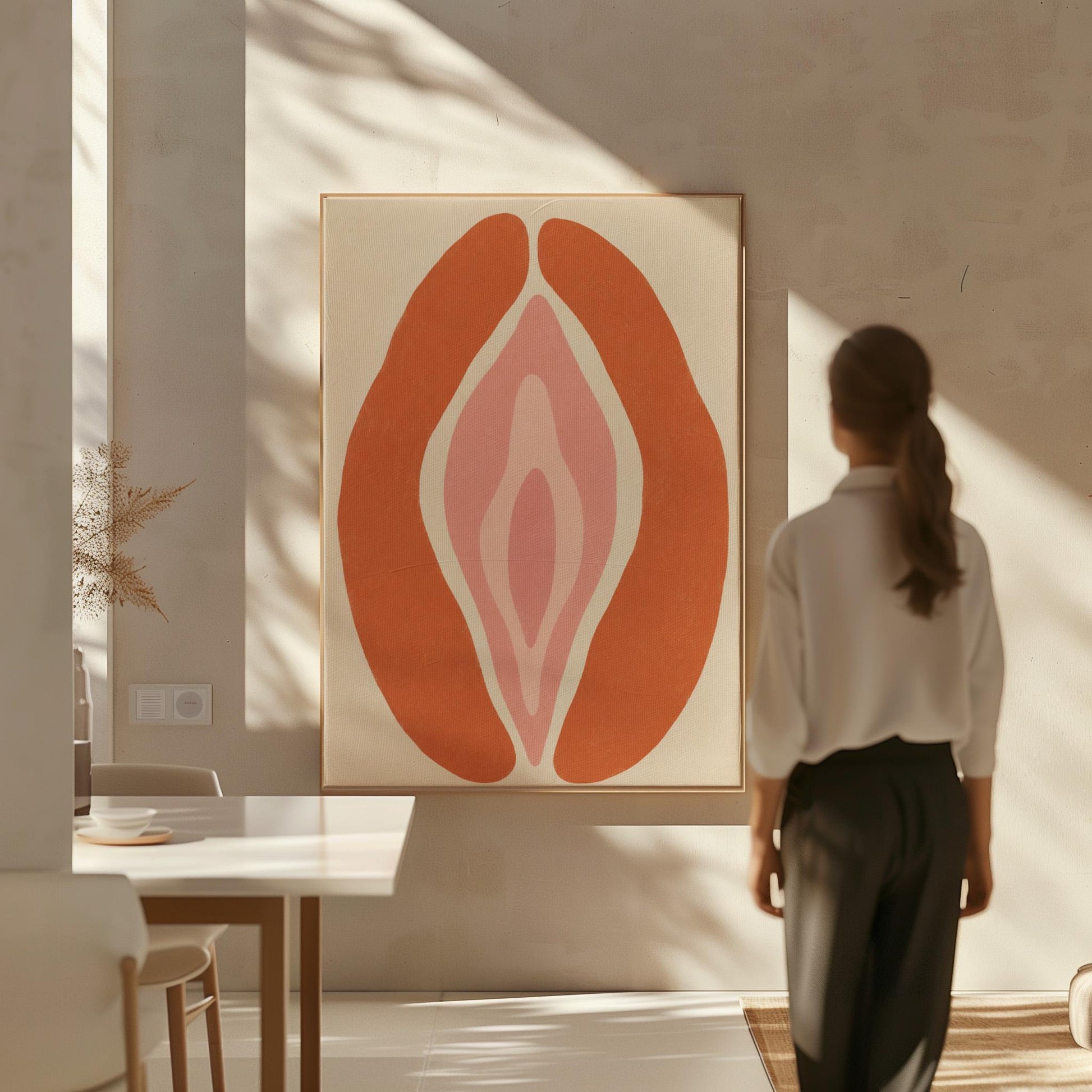 Rust orange arcs curving around a nested blush pink core on sand, canvas wall art seen in a warm interior with natural light