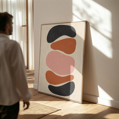 Five stacked pebble shapes in charcoal rust and blush on cream, canvas print shown in a sunlit, contemporary room