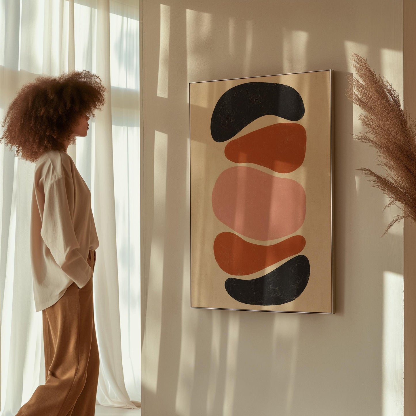 Five stacked pebble shapes in charcoal rust and blush on cream, canvas wall art seen in a warm interior with natural light