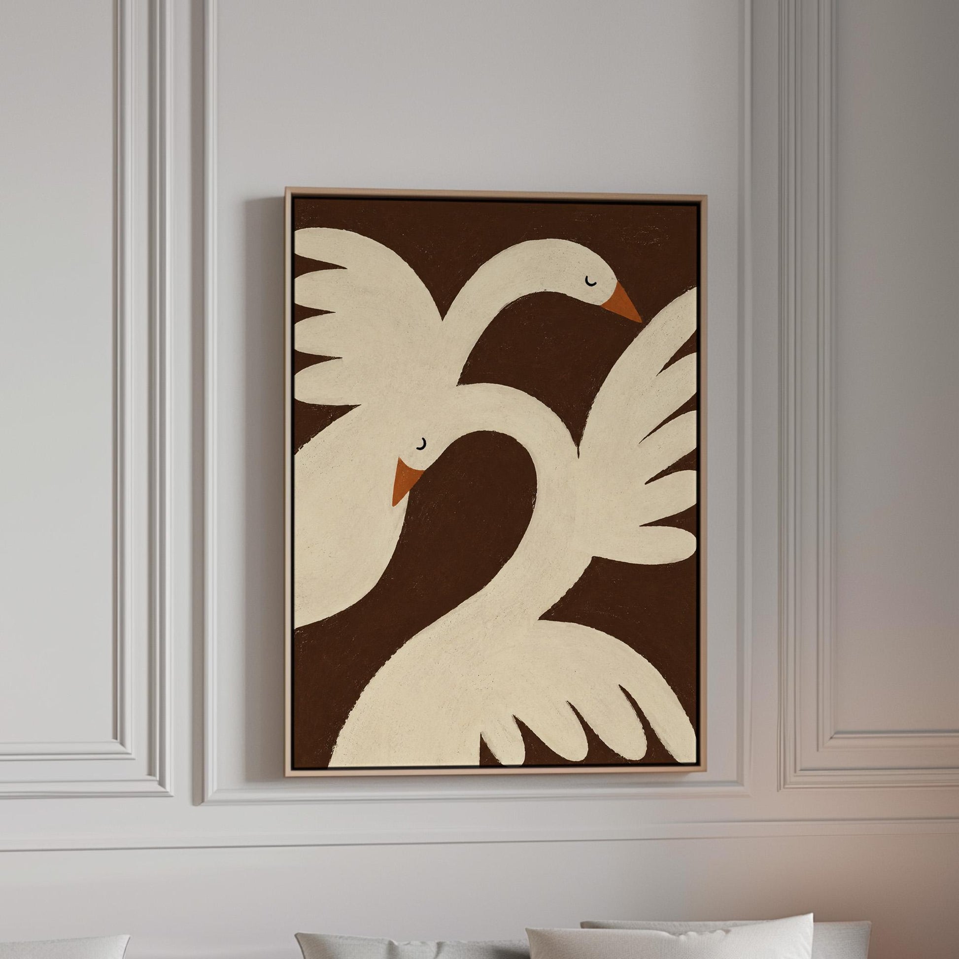 Two cream doves with orange beaks crossing wings on dark brown, canvas print in a bright room with natural daylight