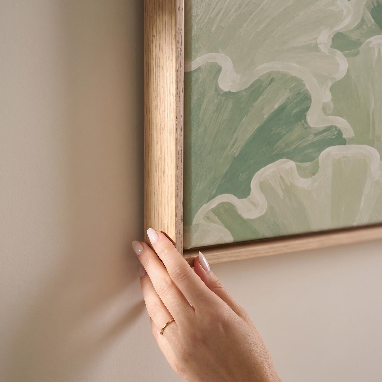 Ruffled leafy fan shapes in sage green rows, canvas print shown at full size in a light-filled bedroom