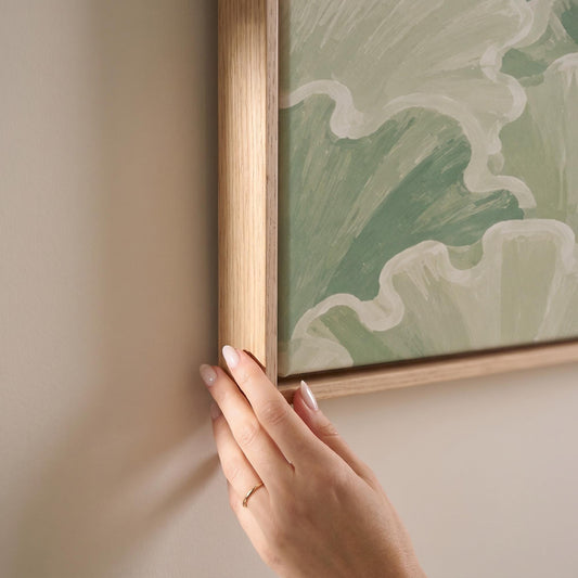 Ruffled leafy fan shapes in sage green rows, canvas print shown at full size in a light-filled bedroom