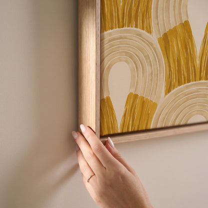 Rows of golden ochre arch shapes, canvas print shown at full size in a light-filled bedroom