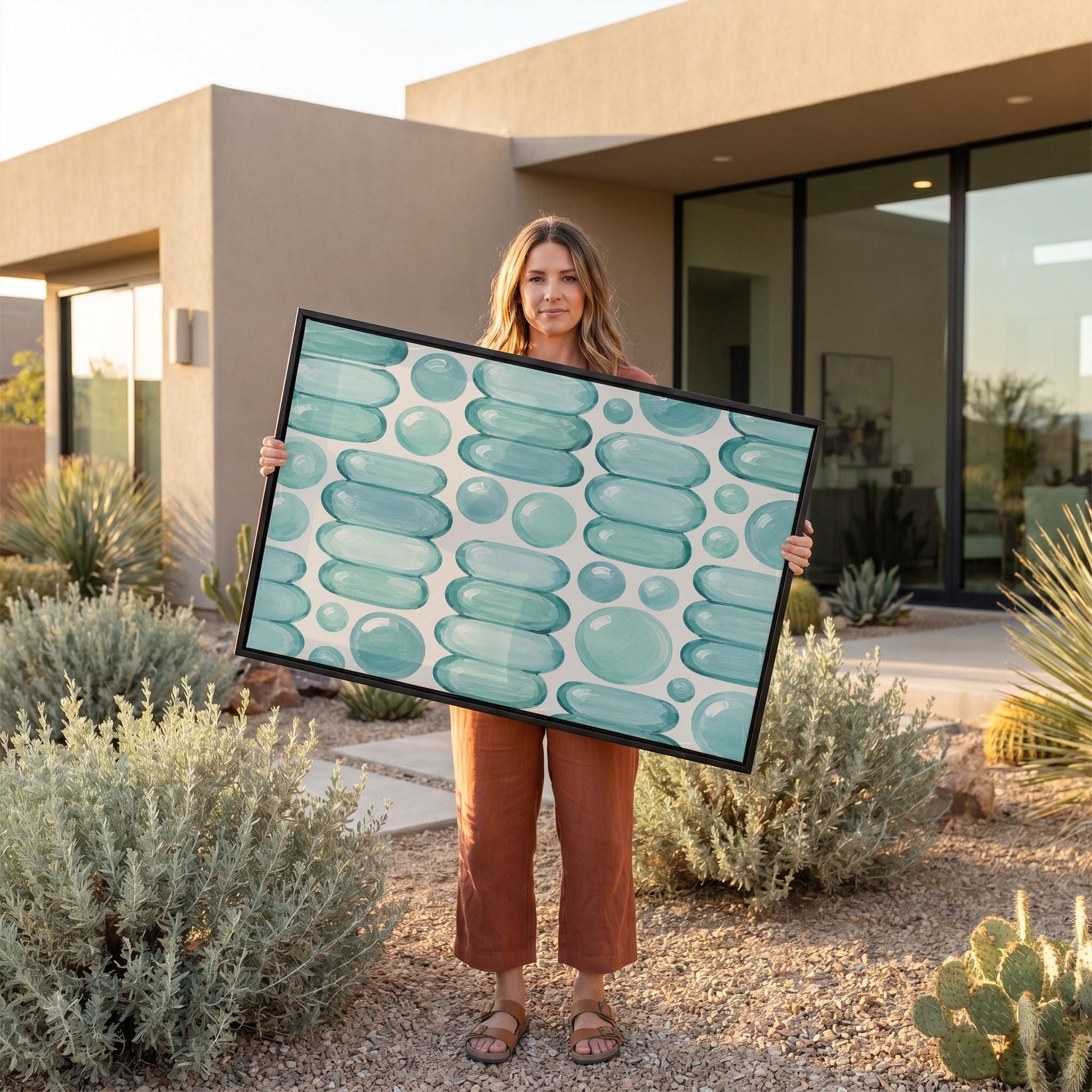 Rows of teal water drop and capsule shapes, canvas print hanging in a calm, modern living space