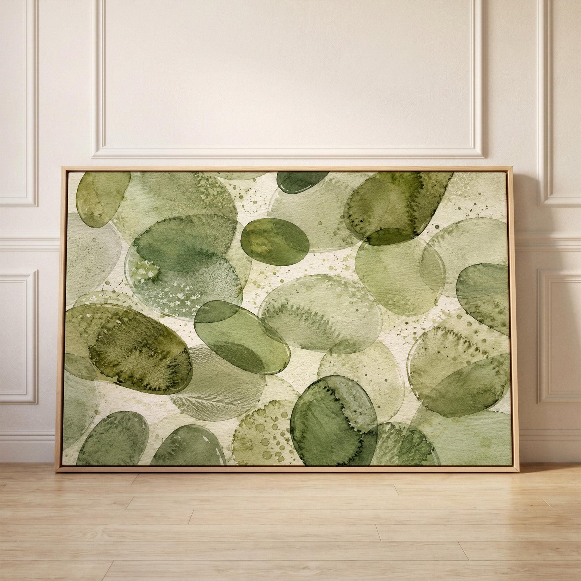 Overlapping olive green stone shapes, canvas print held up against a sunlit bedroom wall