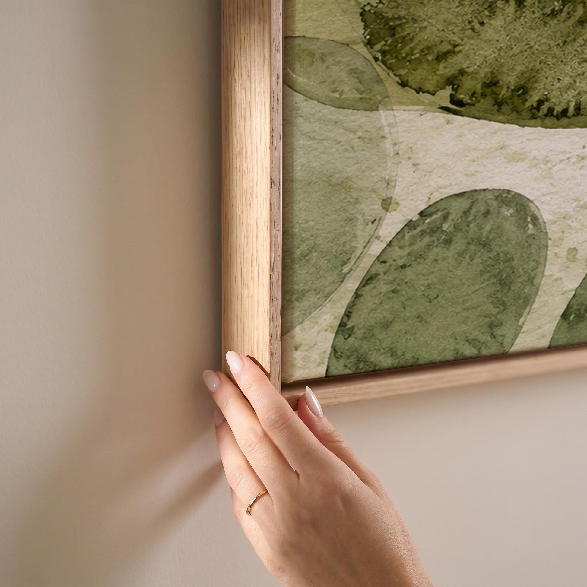 Overlapping olive green stone shapes, canvas print shown at full size in a light-filled bedroom