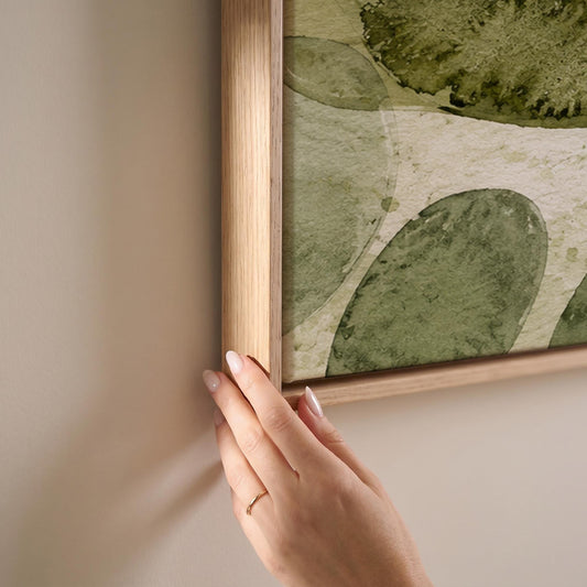 Overlapping olive green stone shapes, canvas print shown at full size in a light-filled bedroom