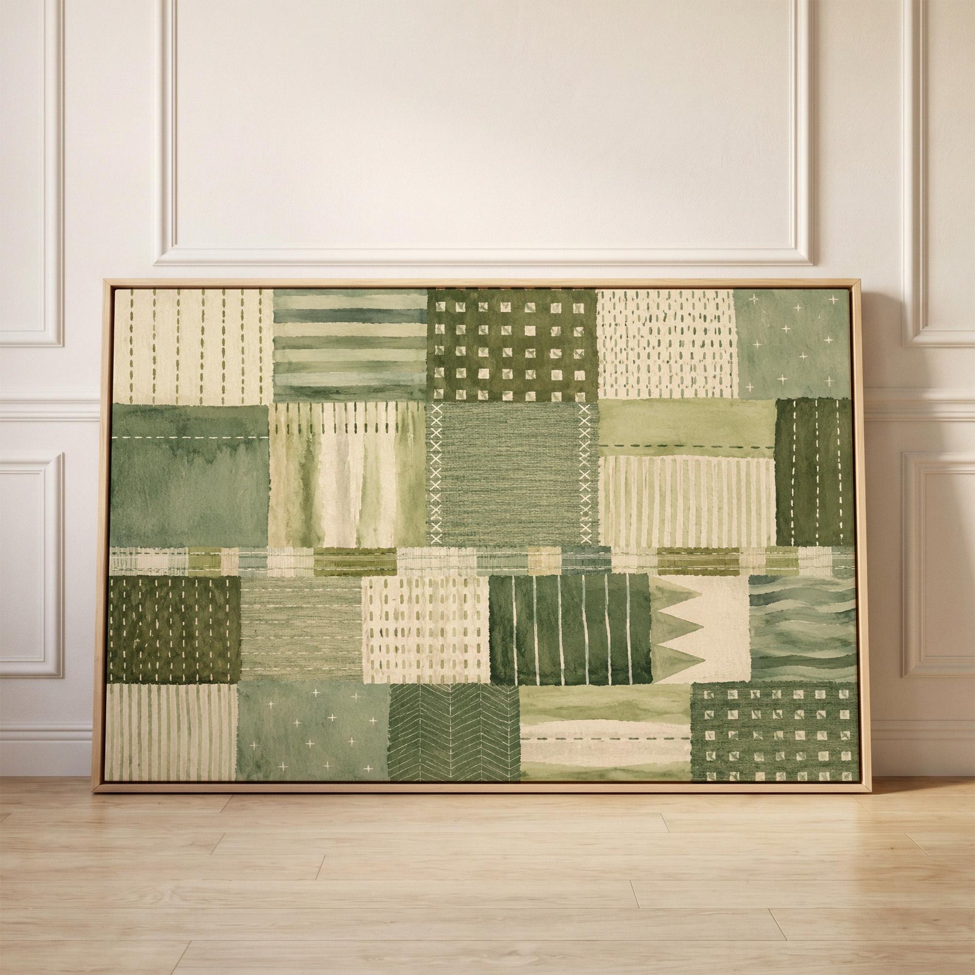 Quilted patchwork of olive green blocks, canvas print held up against a sunlit bedroom wall