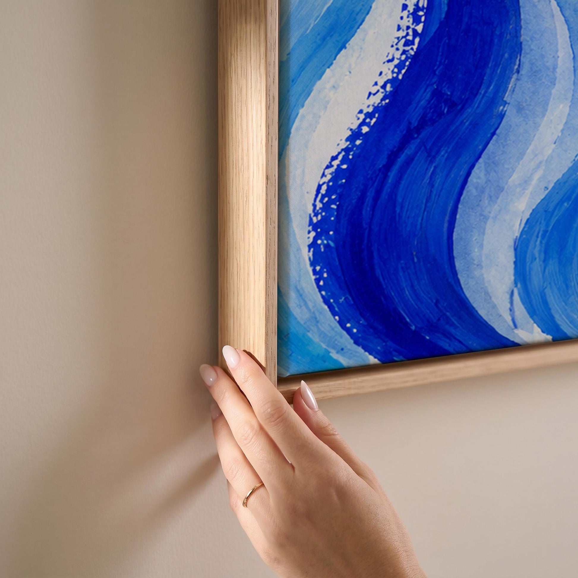 Bold cobalt wave currents across wide canvas, canvas print shown at full size in a light-filled bedroom
