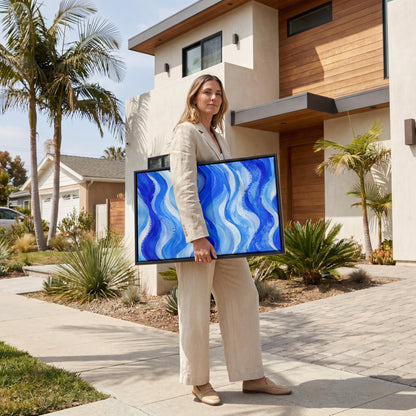 Bold cobalt wave currents across wide canvas, canvas wall art seen in a warm interior with natural light