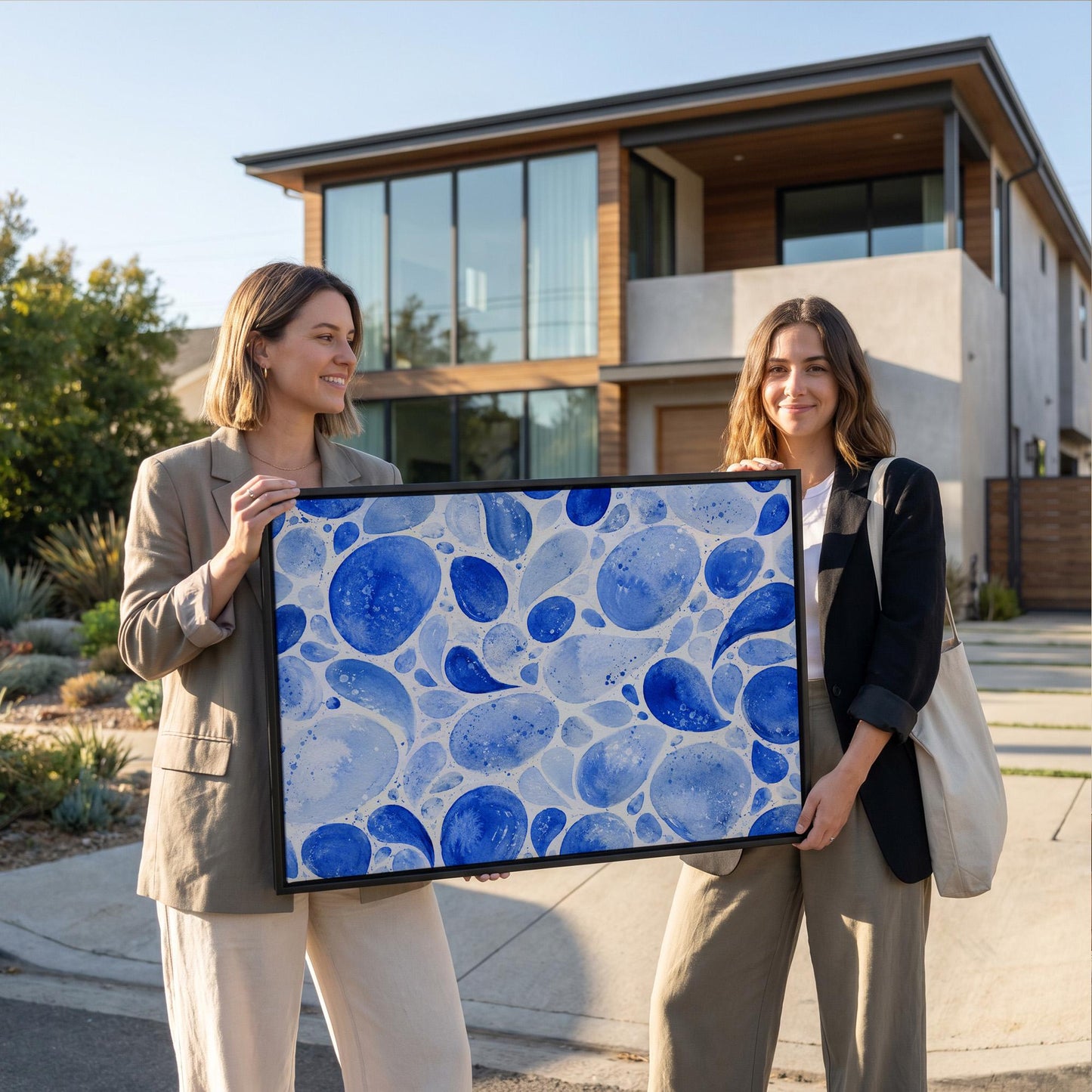 Watercolor blue pebbles spread across wide frame, canvas print shown to scale in a furnished room